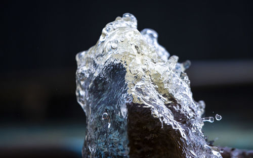Close-up of frozen water against black background