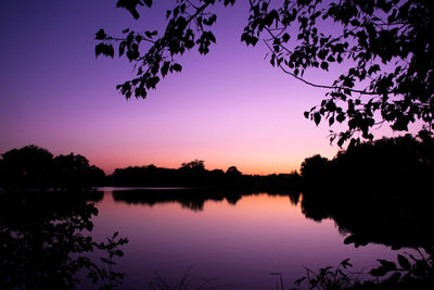 Scenic view of lake against romantic sky at sunset