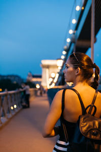 Rear view of woman walking on a bridge