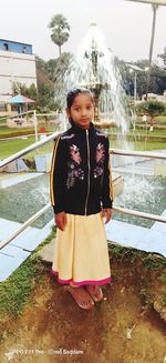 Portrait of girl standing against water