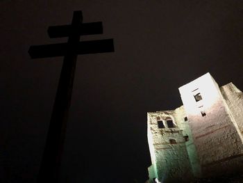 Low angle view of cross at night