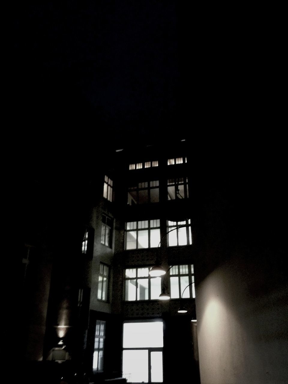 architecture, built structure, building exterior, window, night, low angle view, building, illuminated, residential structure, residential building, dark, city, copy space, clear sky, no people, house, glass - material, outdoors, facade, sky