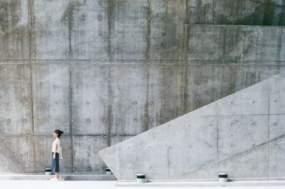 Full length of woman standing by railing