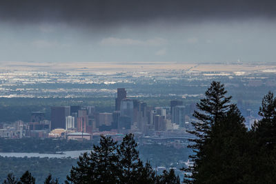 Scenic view of city during winter against sky