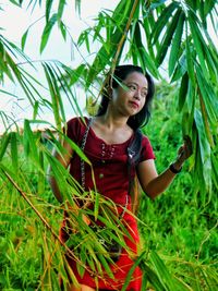 Woman looking away while standing on field