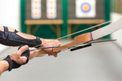 Close-up of man holding bow