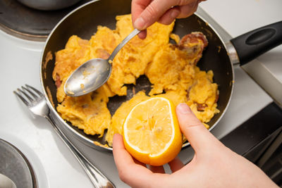 Midsection of person preparing food in kitchen