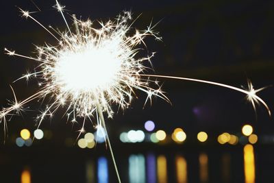 Low angle view of firework display at night