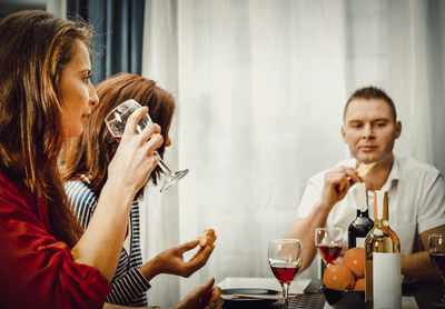 Young couple sitting in a drinking glass