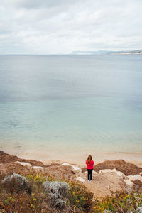 Rear view of woman standing on beach