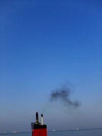 Smoke emitting from chimney against sky