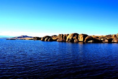 Scenic view of sea against clear blue sky