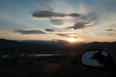 Silhouette landscape against sunset sky