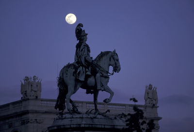 Low angle view of statue against clear sky at night