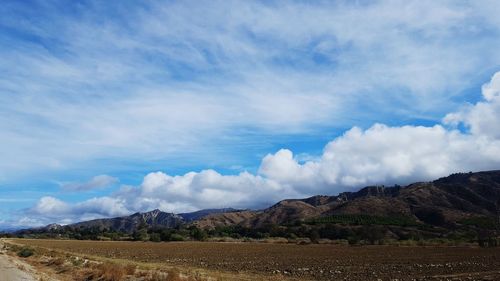 View of countryside landscape against blue sky