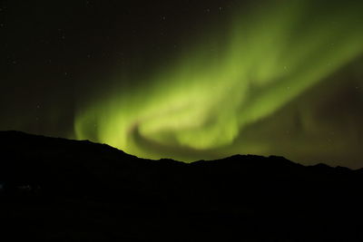 Low angle view of silhouette mountain against sky at night