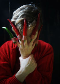 Portrait of woman covering face with hands