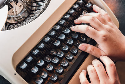 Cropped hands using typewriter