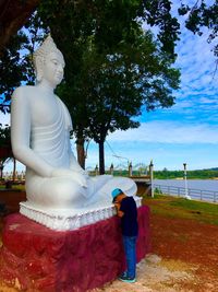 Statue of buddha against trees