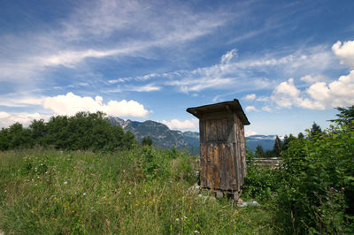 Built structure on field against sky