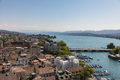 High angle view of city by sea against sky