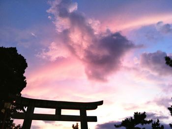 Low angle view of silhouette trees against sky