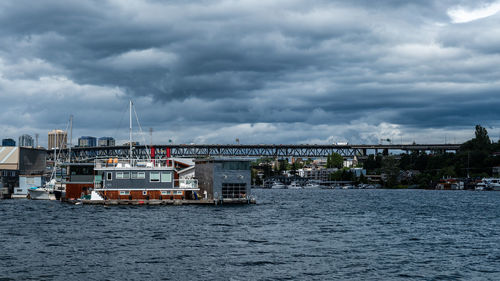 Bridge over river against cloudy sky