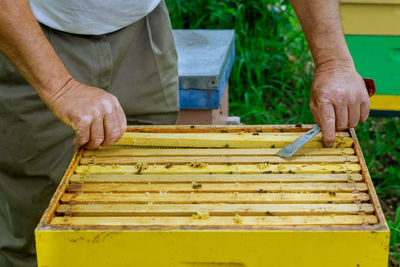 Low section of man working on cutting board