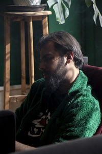 Portrait of young man sitting on chair