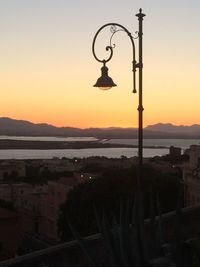 Street light against orange sky