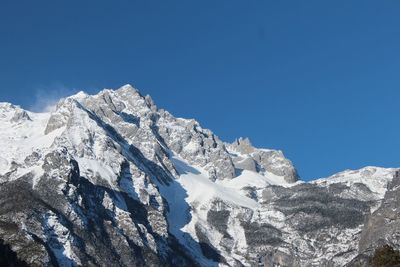 Low angle view of mountain against cloudy sky
