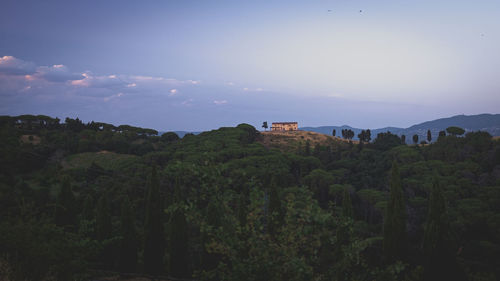 Scenic view of trees and mountains against sky