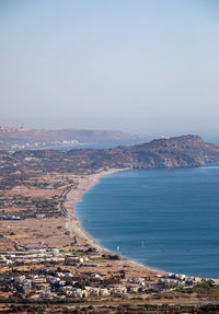 High angle view of townscape by sea against sky