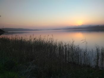 Scenic view of lake against sky during sunset