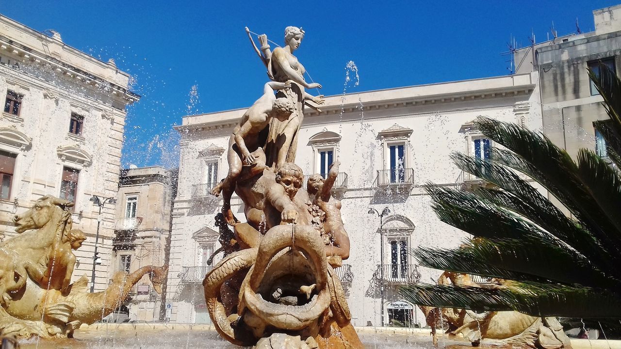 LOW ANGLE VIEW OF STATUE OUTSIDE BUILDING