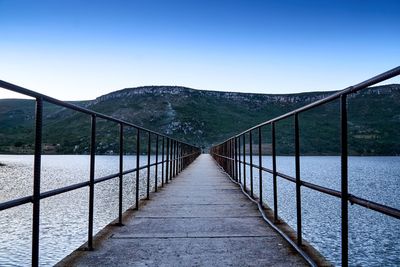 Empty footbridge over lake