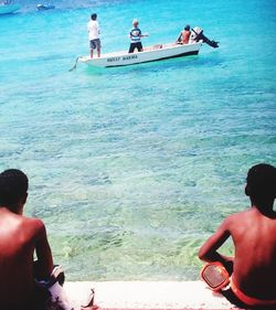 People sitting on boat in sea