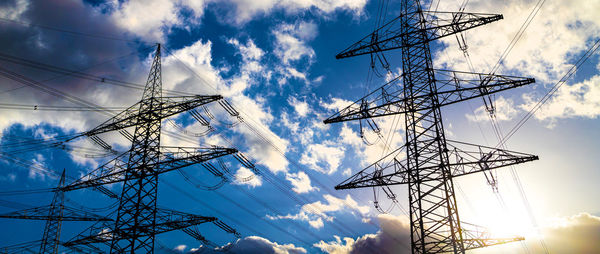 Low angle view of electricity pylon against sky