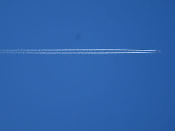 Airplane flying against clear blue sky