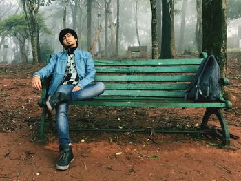 Portrait of young man sitting on bench