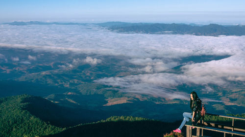 People standing on mountain against sky