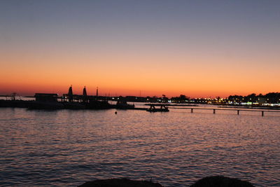 Scenic view of sea against clear sky at sunset