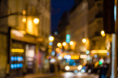 Defocused image of illuminated city street at night