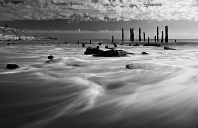 Scenic view of sea against cloudy sky