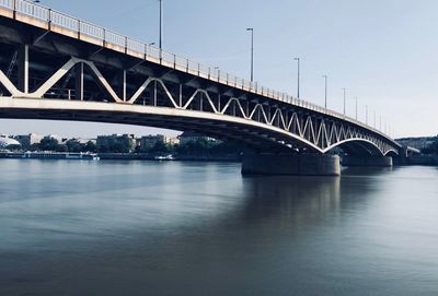 Low angle view of bridge over river against sky