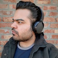 Portrait of young man against wall