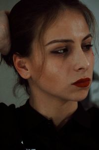 Close-up portrait of young woman looking away