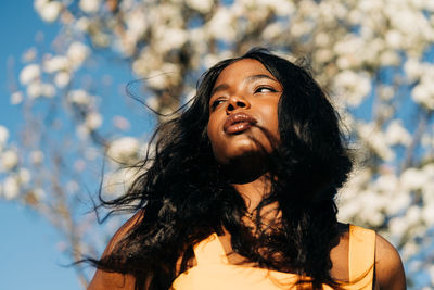 Portrait of a young woman looking away outdoors