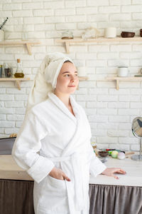 Young woman standing at home