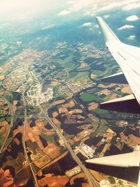 Cropped image of airplane wing over landscape